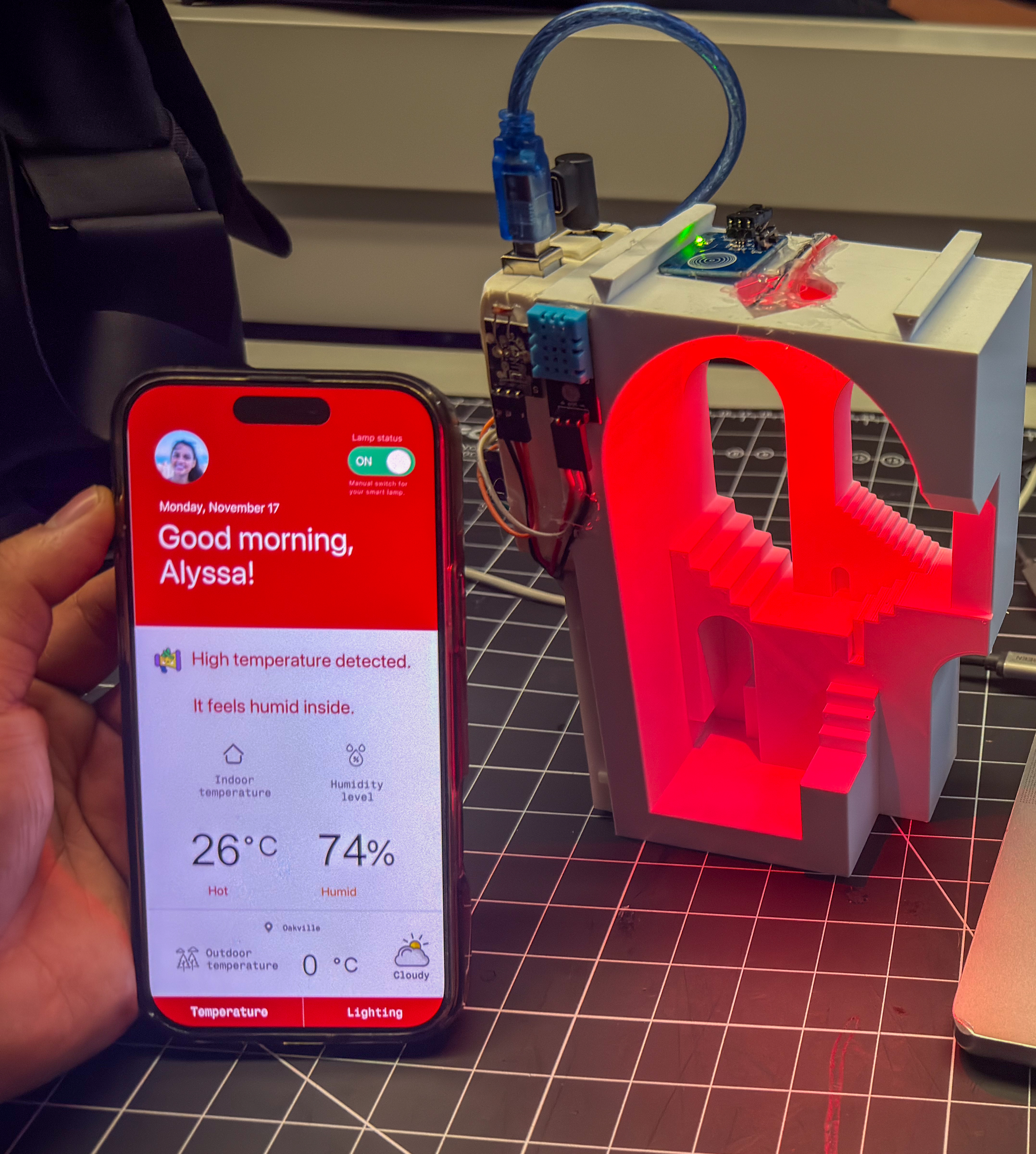 The final prototype in action with the lamp and mobile interface updating instantly based on real temperature and humidity readings.
