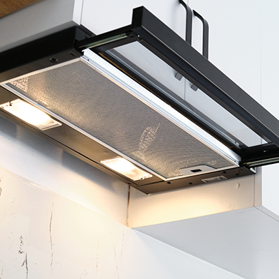 The continuous humming of a range hood fan, low-pitched airflow sound.